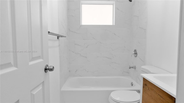 full bathroom with toilet, tiled shower / bath combo, and vanity