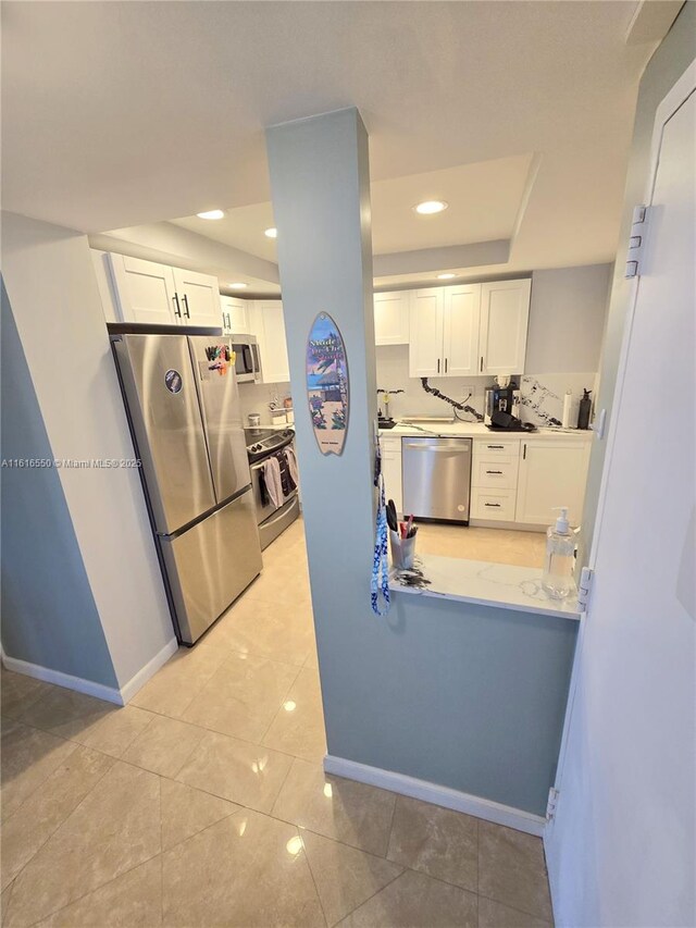 kitchen featuring stainless steel appliances and white cabinets