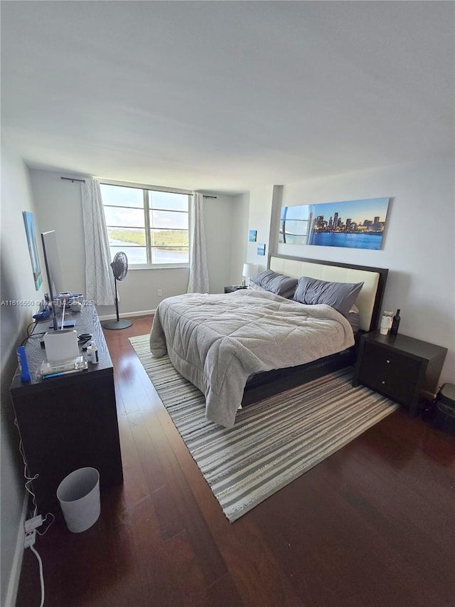 bedroom with dark wood-type flooring