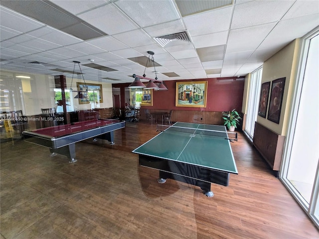 game room with dark hardwood / wood-style floors and a paneled ceiling