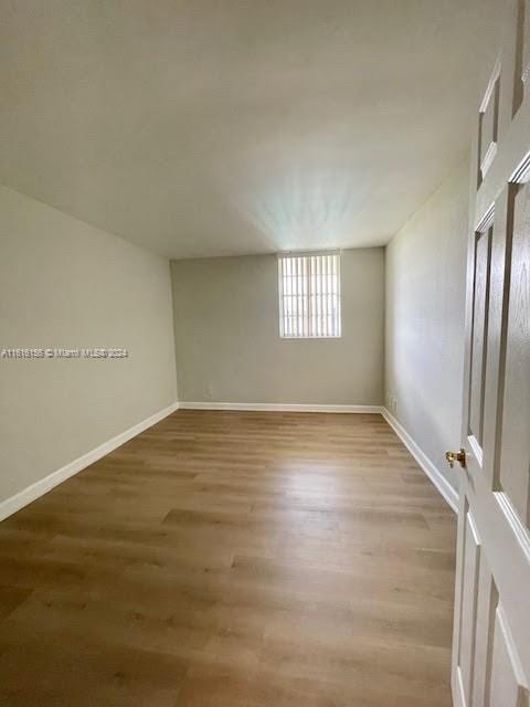 spare room with hardwood / wood-style floors