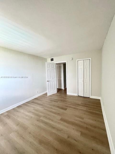 unfurnished bedroom featuring hardwood / wood-style flooring