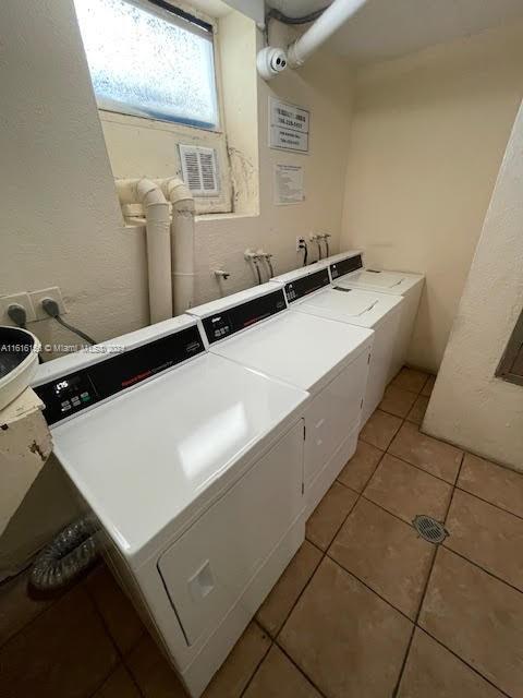 washroom featuring independent washer and dryer and light tile patterned floors