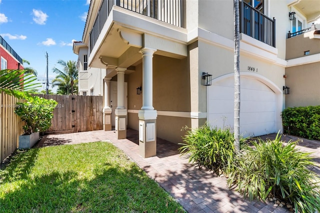 property entrance with a yard and a balcony