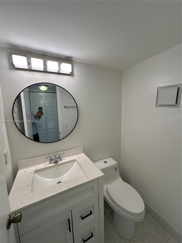 bathroom with tile patterned floors, vanity, and toilet