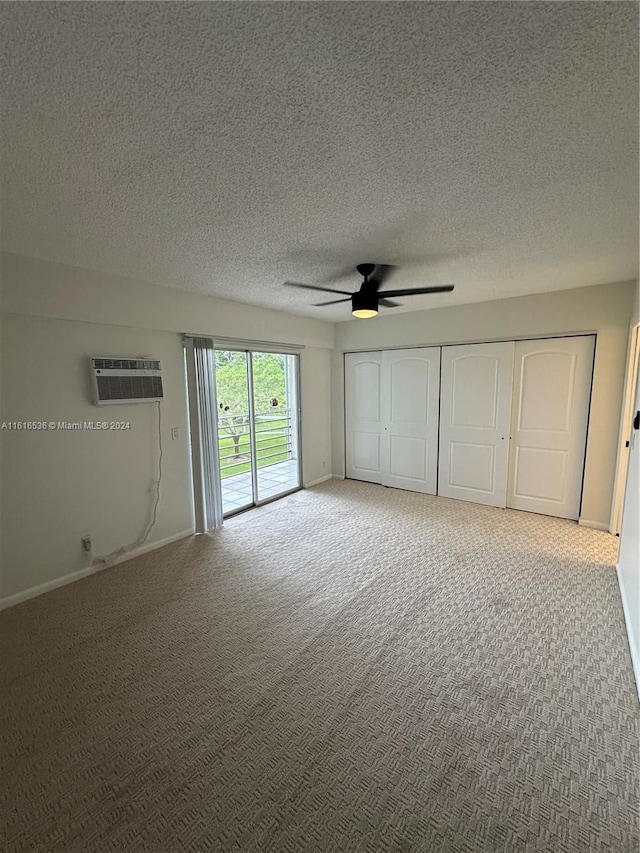 unfurnished bedroom with carpet floors, access to outside, a wall mounted AC, and ceiling fan