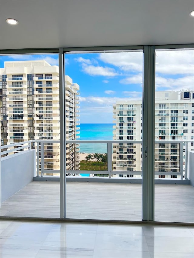 doorway featuring floor to ceiling windows and a water view