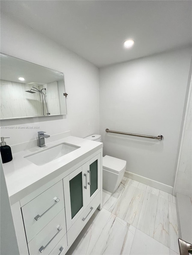 bathroom with vanity, toilet, and walk in shower