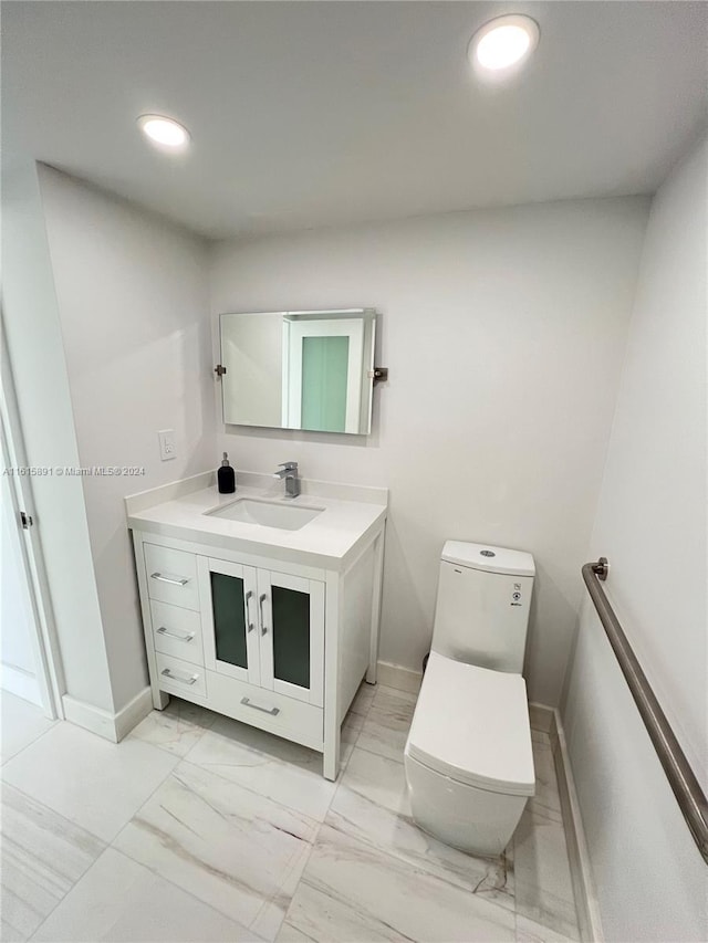 bathroom featuring vanity and toilet