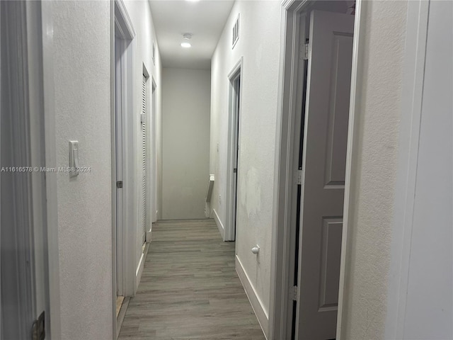 corridor featuring light hardwood / wood-style floors