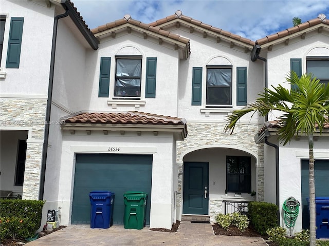 mediterranean / spanish home featuring a garage