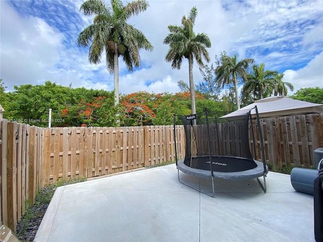 view of patio featuring a fenced backyard and a trampoline