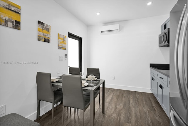 dining area featuring dark wood-type flooring and a wall mounted AC