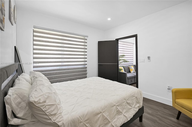 bedroom with dark hardwood / wood-style flooring