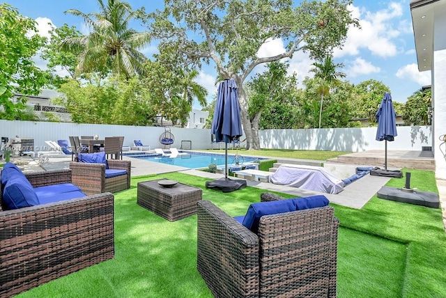 view of yard featuring a fenced in pool and a patio area