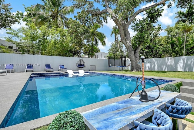 view of pool with a lawn and a patio area