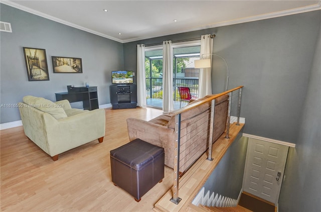 living room featuring hardwood / wood-style flooring and crown molding