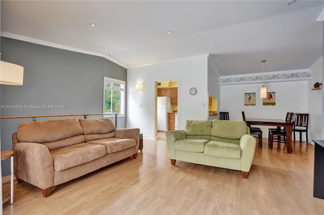 living area featuring light wood-type flooring, baseboards, lofted ceiling, and ornamental molding