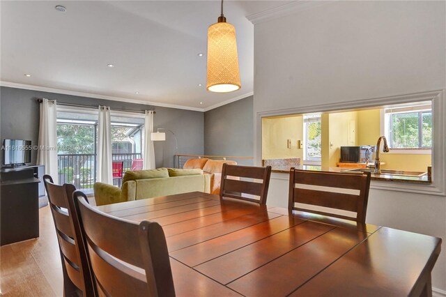 dining area featuring wood finished floors, recessed lighting, a healthy amount of sunlight, and ornamental molding