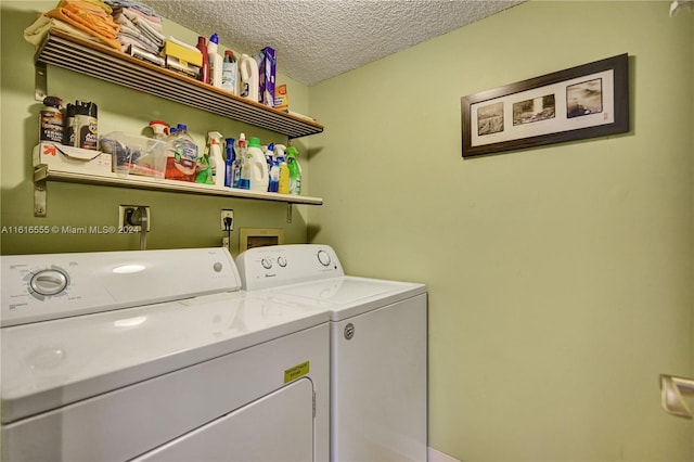 laundry room featuring a textured ceiling, laundry area, and washing machine and clothes dryer