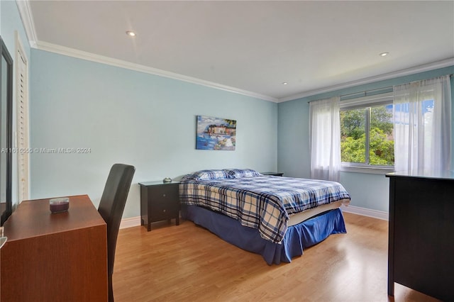 bedroom featuring light wood-type flooring and ornamental molding