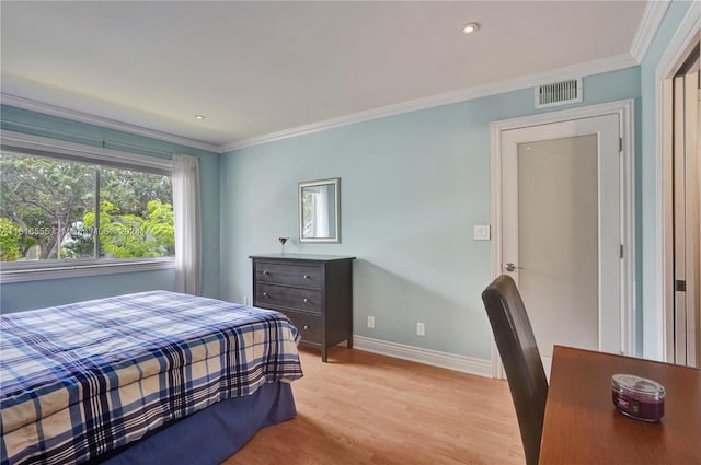 bedroom with crown molding and light wood-type flooring