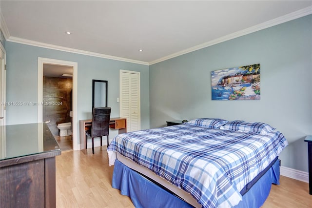 bedroom featuring crown molding, light hardwood / wood-style flooring, and connected bathroom