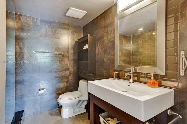 bathroom featuring vanity, tile walls, toilet, and tile patterned floors