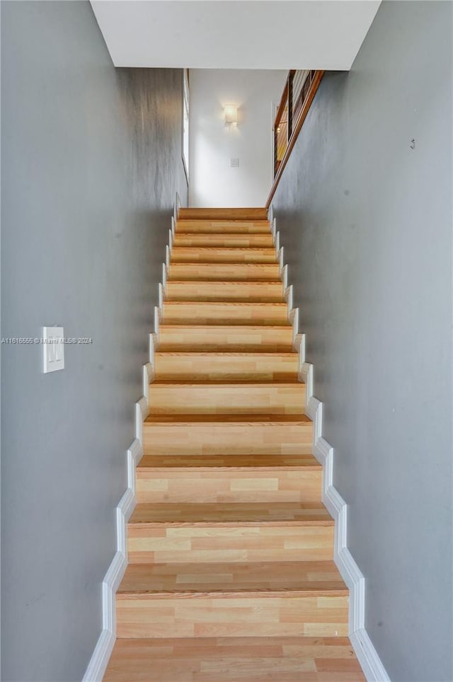 stairs featuring hardwood / wood-style flooring