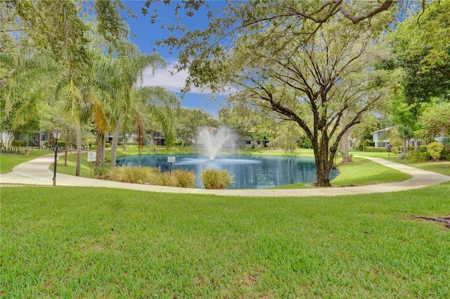 view of community featuring a water view and a lawn