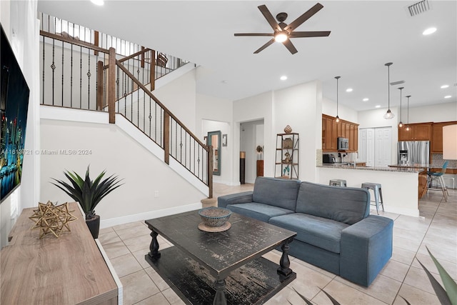 living room with ceiling fan and light tile patterned flooring