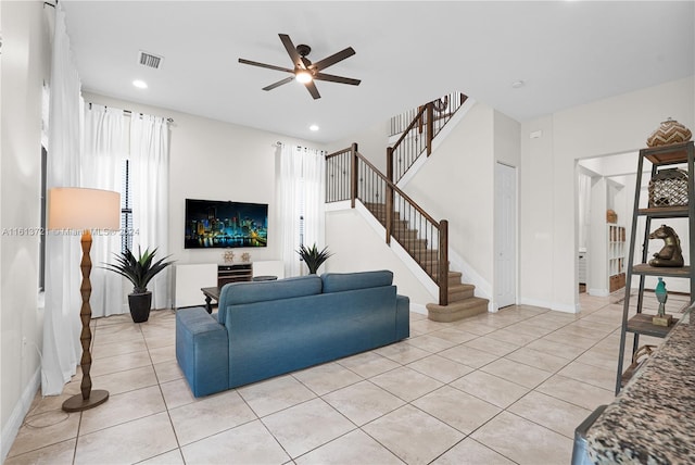 living room with ceiling fan and light tile patterned flooring