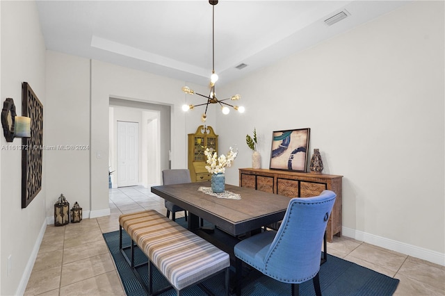 dining space featuring a notable chandelier and light tile patterned flooring