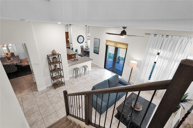 stairway featuring french doors, tile patterned floors, ceiling fan, and lofted ceiling