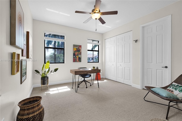 home office featuring ceiling fan and light carpet