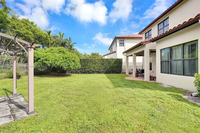 view of yard featuring ceiling fan and a patio