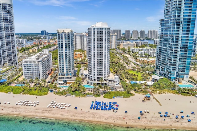 birds eye view of property with a water view and a view of the beach