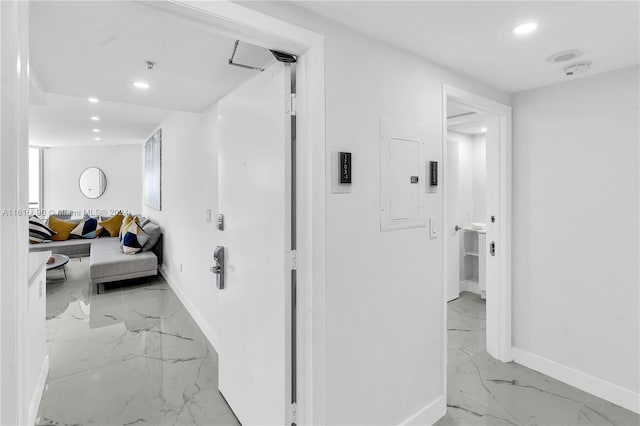 hall featuring electric panel and light tile patterned flooring