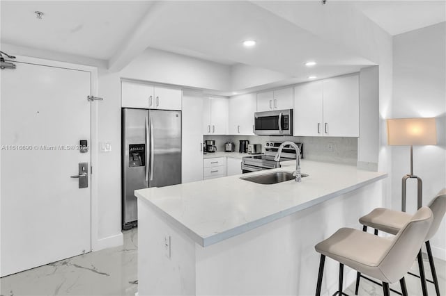 kitchen featuring appliances with stainless steel finishes, backsplash, beamed ceiling, and white cabinets