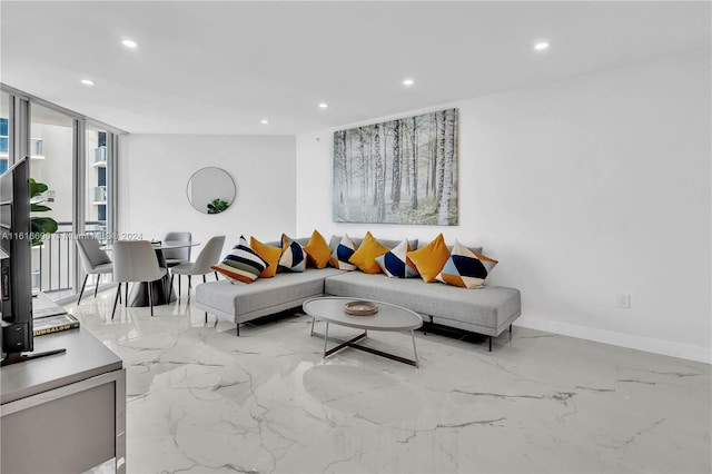 living room featuring light tile patterned flooring and a wall of windows