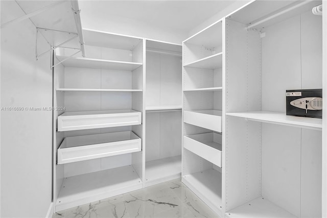 spacious closet featuring light tile patterned flooring