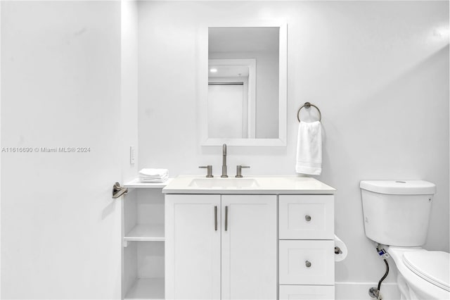 bathroom with toilet and vanity