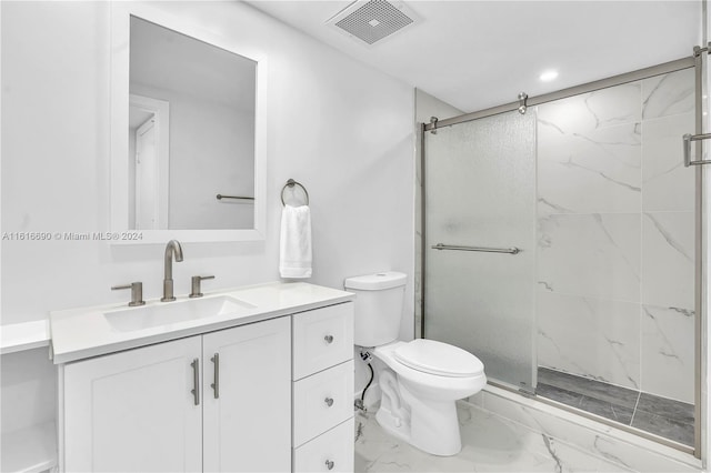 bathroom with toilet, tile patterned floors, vanity, and a shower with shower door