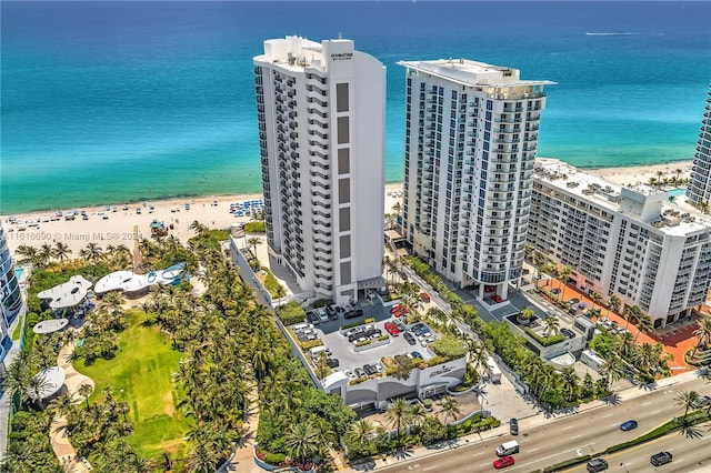 drone / aerial view featuring a water view and a beach view