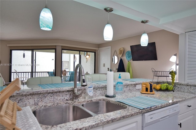 kitchen featuring pendant lighting, dishwasher, sink, and white cabinets