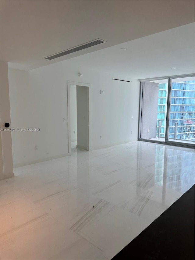 unfurnished room with floor to ceiling windows