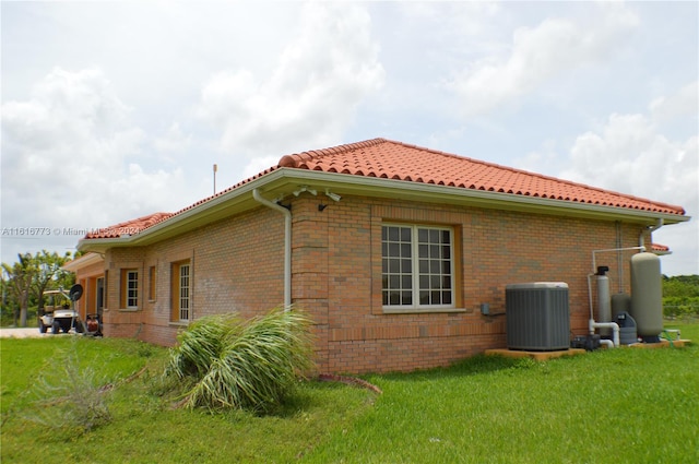 view of home's exterior featuring a yard and cooling unit