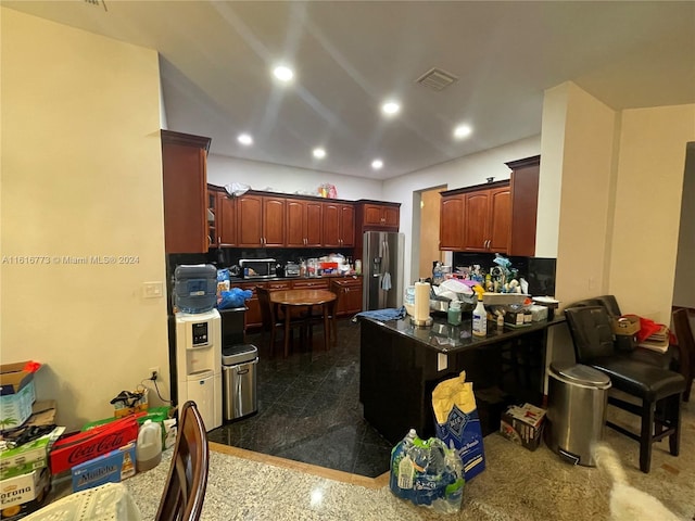 31002 SW 212th Ave, Homestead, FL 33030 - kitchen with stainless steel fridge, recessed lighting, backsplash, a peninsula, and granite floors