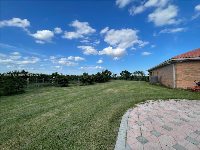 view of yard featuring a patio area and central AC unit