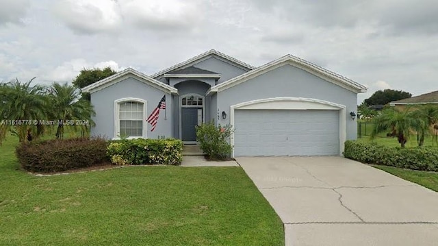 ranch-style house with a garage and a front lawn